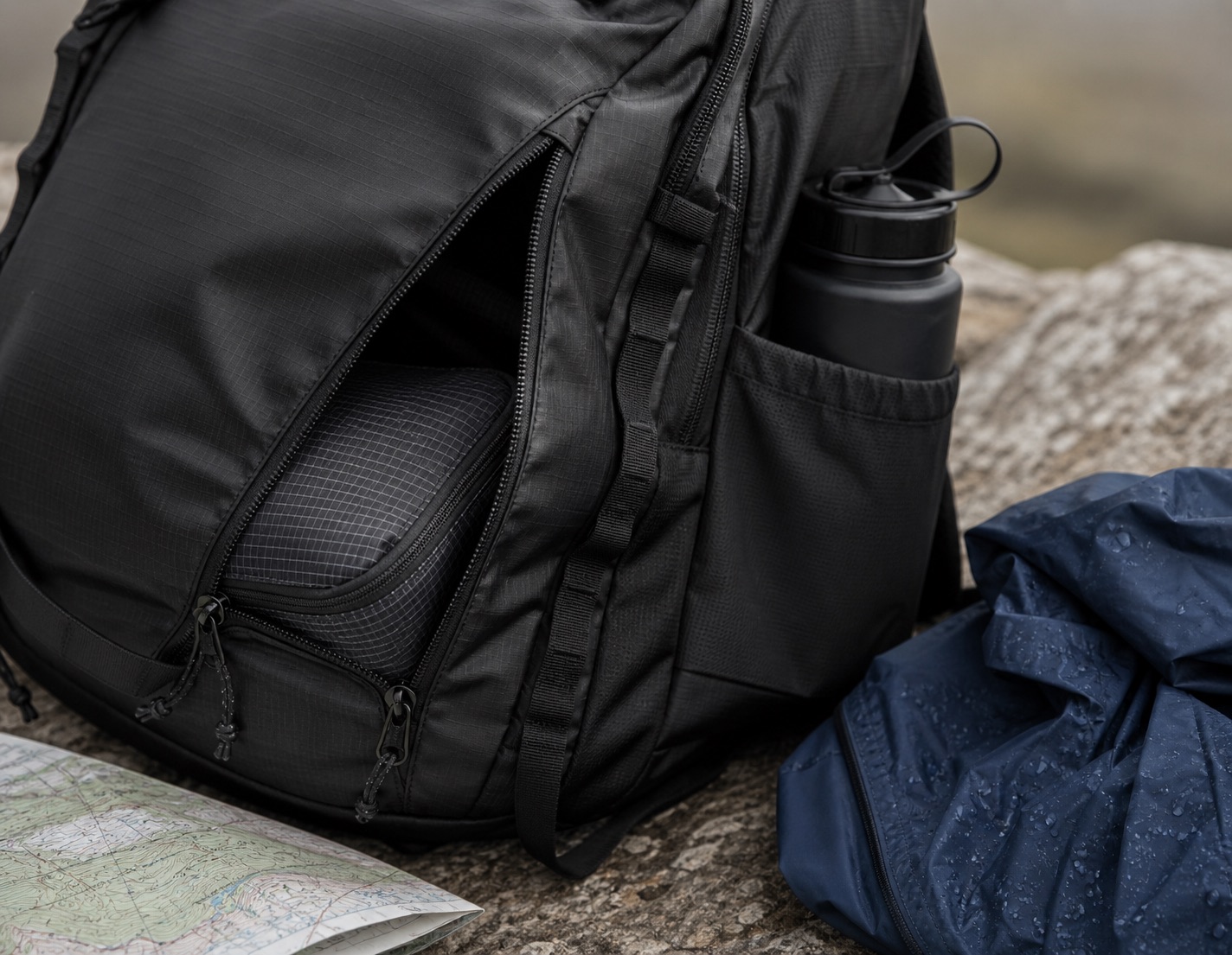 Patagonia-style Black Hole 32L backpack detail with walking and travel kit